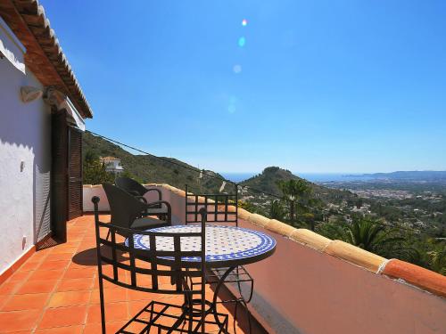 a table and chairs on a balcony with a view at Holiday Home Nostra by Interhome in Jávea