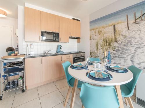 a kitchen and dining room with a table and chairs at Apartment Oase with parking by Interhome in Mispelburg