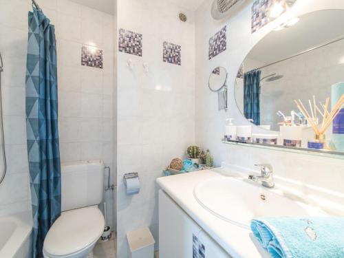a bathroom with a toilet and a sink and a mirror at Apartment Oase with parking by Interhome in Mispelburg