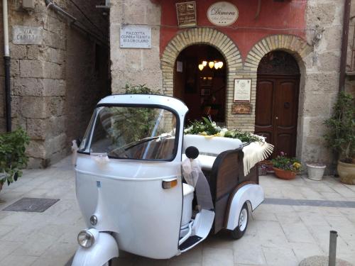 a small car parked in front of a building at Antica Dimora San Girolamo in Licata