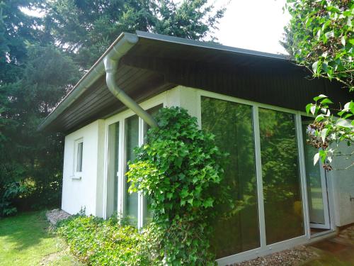 a house with a large window with a plant at Das FRITZ Hotel Schwerin schöne Lage im Grünen mit regionaler Küche kostenfreien Parkplätzen und E Ladestation in Schwerin