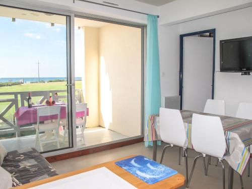 un salon avec une table à manger et un balcon dans l'établissement Apartment Grand Pavois-5 by Interhome, à Mimizan-Plage
