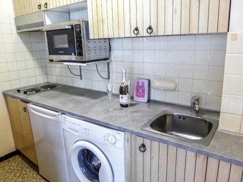 une cuisine avec une machine à laver et un évier dans l'établissement Studio L'Aiguille du Midi-7 by Interhome, à Chamonix-Mont-Blanc