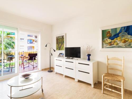 a living room with a tv and a table at Apartment Parque Central by Interhome in Estepona