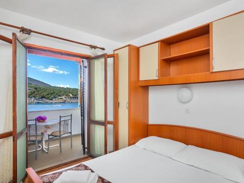 a bedroom with a bed and a view of the water at Apartment Cico-8 by Interhome in Selca kod Bogomolja