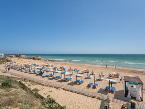 a beach with chairs and umbrellas and the ocean at Villa Mira Mar Galé 440m from the Beach by Interhome in Patroves