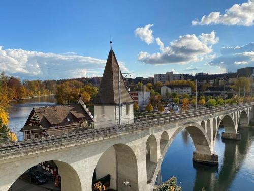 a bridge over a river with a church on it at Private Studio Apartment in Bremgarten in Bremgarten