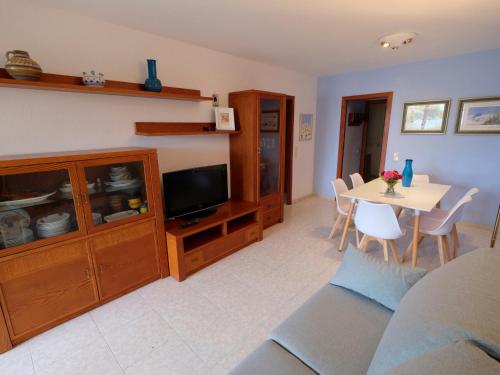 a living room with a tv and a table with chairs at Apartment Costa Blanca II by Interhome in Cambrils