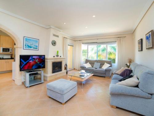 a living room with a couch and a tv at Holiday Home Casa Kate by Interhome in Calpe