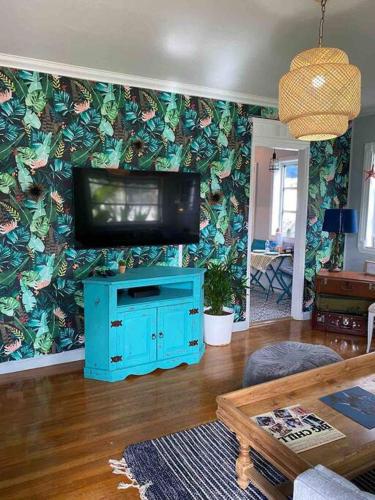 a living room with a flat screen tv on a wall at Cozy Cottage Near Beach in Hollywood