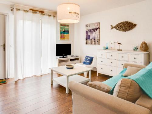 a living room with a couch and a table at Apartment Cantegrit by Interhome in Capbreton