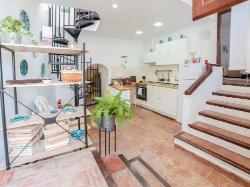 a kitchen with a spiral staircase in a house at Holiday Home Cueva de Lindaraja by Interhome in Granada
