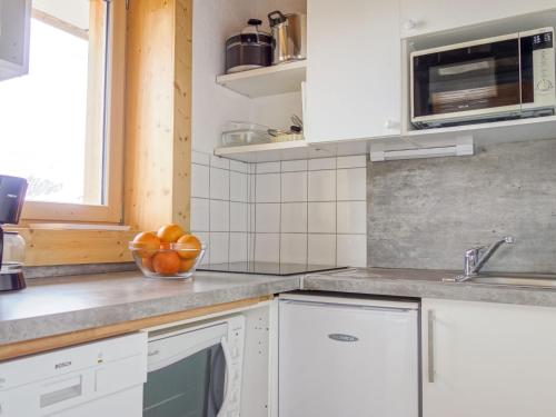 une cuisine avec un bol de fruits sur le comptoir dans l'établissement Apartment Horizon 2000 - Le Lac by Interhome, à Tignes