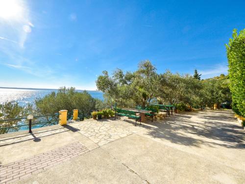 a picnic area with a view of the ocean at Apartment Vukić-1 by Interhome in Tribanj-Krušćica