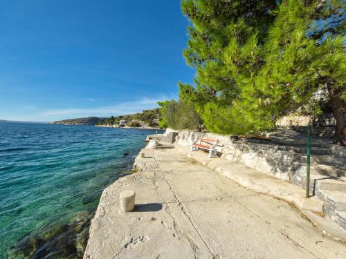 a walkway next to a body of water at Apartment Vukić-1 by Interhome in Tribanj-Krušćica