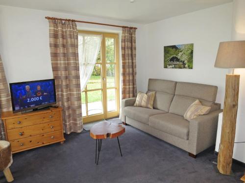 a living room with a couch and a tv at Apartment Wohnung 4 - Am Sonneneck by Interhome in Ruhpolding