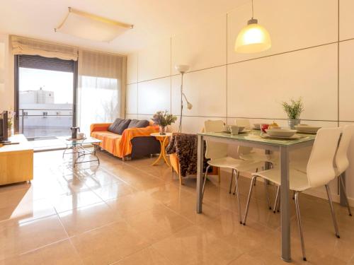 a living room with a table and a couch at Apartment Goleta-1 by Interhome in Cambrils