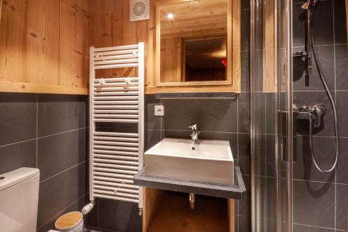 a bathroom with a sink and a shower at Chalet Fauvette in Morzine