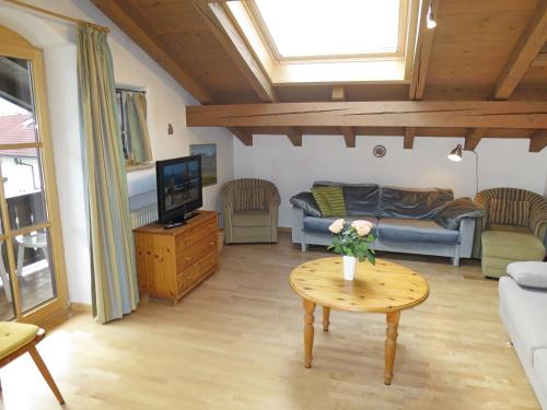 a living room with a couch and a table at Apartment Wohnung 8 - Am Sonneneck by Interhome in Ruhpolding
