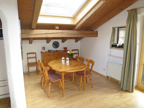a dining room with a wooden table and chairs at Apartment Wohnung 8 - Am Sonneneck by Interhome in Ruhpolding