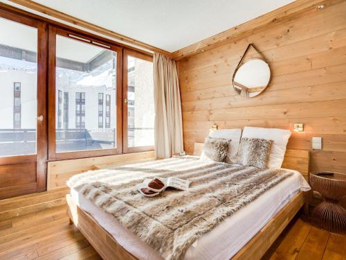 a bedroom with a bed and a large window at Apartment Le Prariond - Val Claret-10 by Interhome in Tignes