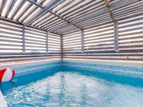 a indoor swimming pool with a large pool of water at Apartment La Porte Génoise by Interhome in Porto-Vecchio
