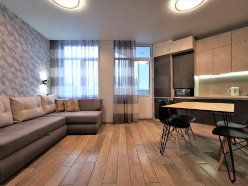 a living room with a couch and a table at Green Apartments in Chernihiv