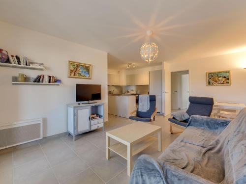 a living room with a couch and a table at Apartment 79 Bay-2 by Interhome in Cavalaire-sur-Mer