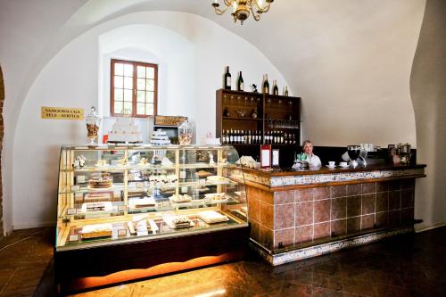 a display case in a room with wine bottles at Zamek w Krasiczynie in Krasiczyn