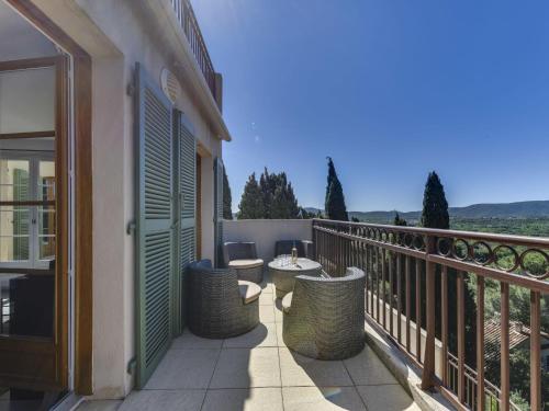 a balcony with a table and chairs on it at Apartment Les Terrasses de Grimaud by Interhome in Grimaud