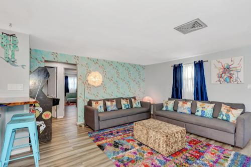 a living room with a couch and a table at MERMAID HOUSE WITH POOL JACUZZI STEPS to SIESTA KEY BEACH in Sarasota