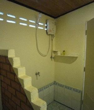 a bathroom with a shower and a brick wall at Moonwalk Lanta Resort in Ko Lanta