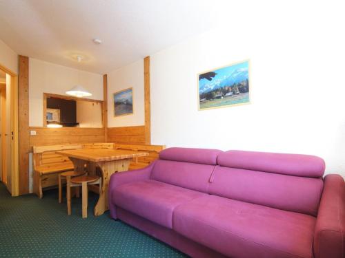 a living room with a purple couch and a table at Apartment Jonquilles-10 by Interhome in Chamonix
