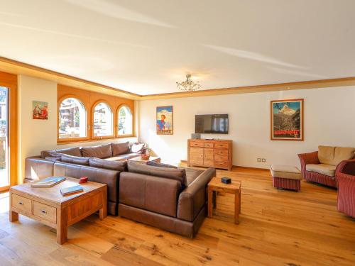 ein Wohnzimmer mit einem Sofa und einem Tisch in der Unterkunft Apartment Whymper by Interhome in Zermatt