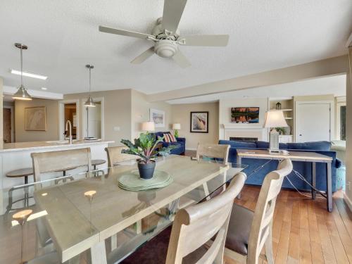 a dining room and living room with a table and chairs at 101 Edgewater Inn in Charlevoix