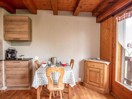 a kitchen with a table and chairs in a room at Studio Les Grets-10 by Interhome in Saint-Gervais-les-Bains