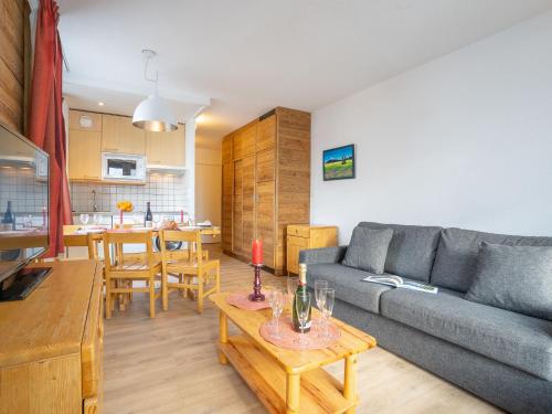 un salon avec un canapé et une table dans l'établissement Apartment Le Prariond - Val Claret-11 by Interhome, à Tignes