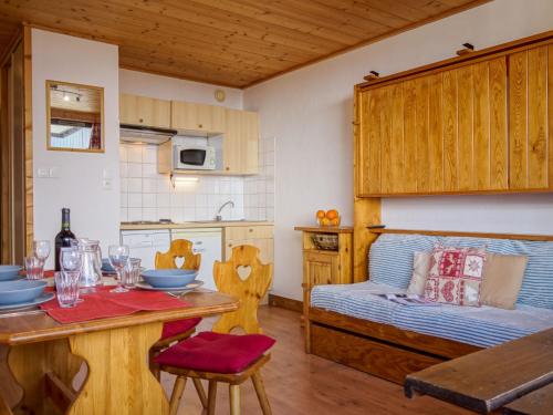 a kitchen with a table and a bed in a room at Studio Les Genepis-3 by Interhome in Tignes