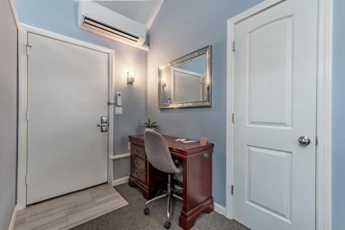 an office with a desk and a door and a chair at Homestead Inn in New Milford