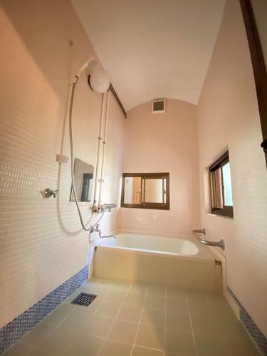 a large bathroom with a tub and a shower at あまね庵 Villa Amane in Sakurai