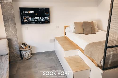 a small bedroom with a bed and a sign on the wall at Gook Home BEACH in Málaga