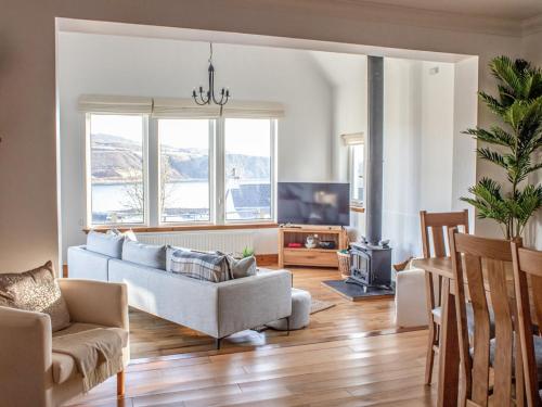 a living room with a couch and a tv at Holiday Home Bay View by Interhome in Uig