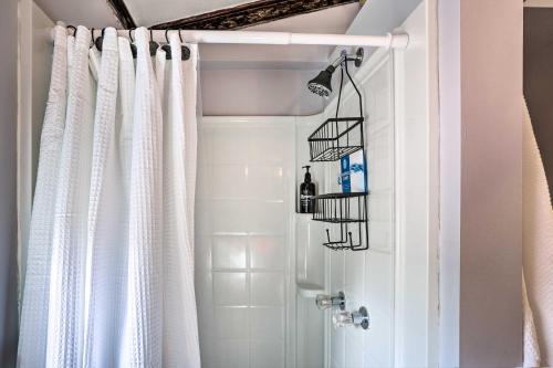 a shower curtain in a bathroom with a white shower at Calming Shenandoah Valley Cabin with Hot Tub! in Luray