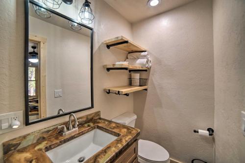 a bathroom with a sink and a mirror and a toilet at Family Home with Fire Pit and Grill about 1 Mi to Slopes! in Angel Fire