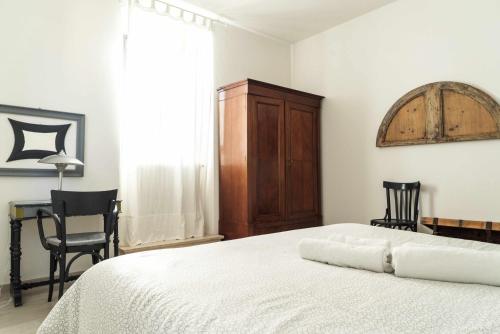 a bedroom with a bed with two chairs and a table at Todi Centro - Le Terrazze di San Fortunato in Todi
