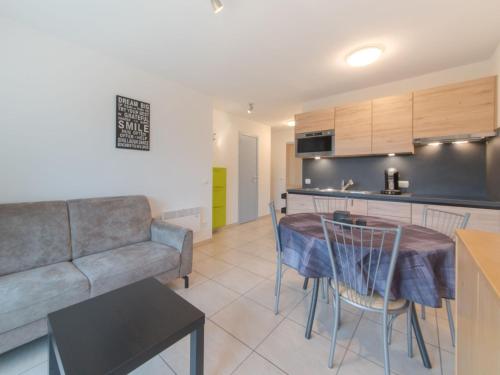 a kitchen and living room with a couch and a table at Studio Deauville II 010 with parking by Interhome in Bredene