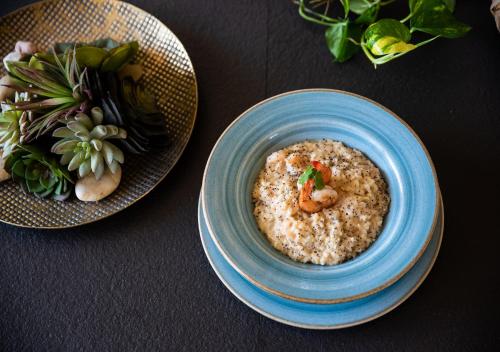 a bowl of rice with shrimp in it on a table at Gardenia Springs - La Finca Buritaca in Buritaca