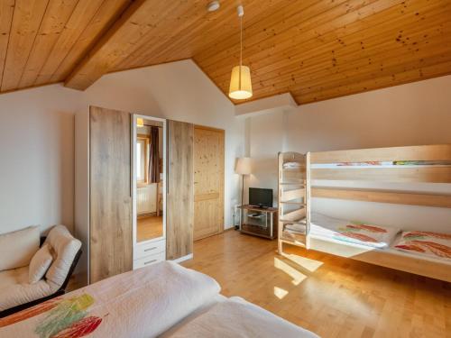 a bedroom with two bunk beds and a mirror at Apartment Pistenblick Gross by Interhome in Hochrindl