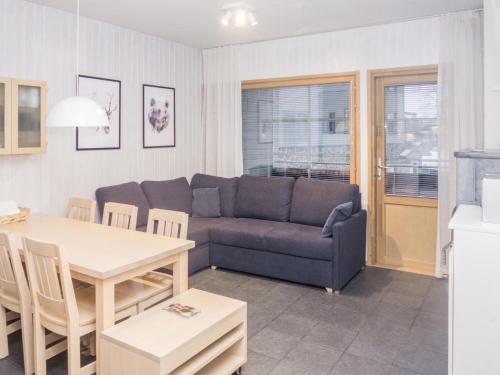 a living room with a couch and a table at Holiday Home Rukatonttu d 15 by Interhome in Ruka