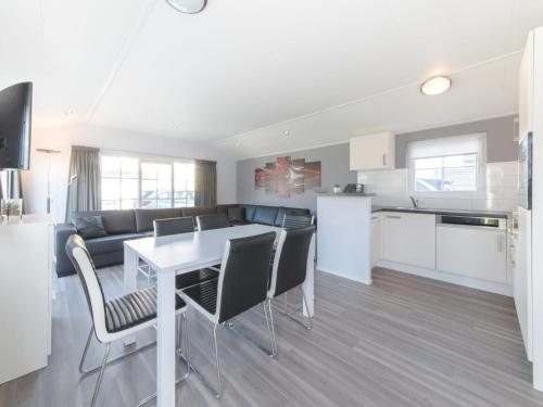 a kitchen and living room with a table and chairs at Holiday Home Park Kerlinga-20 by Interhome in Bredene